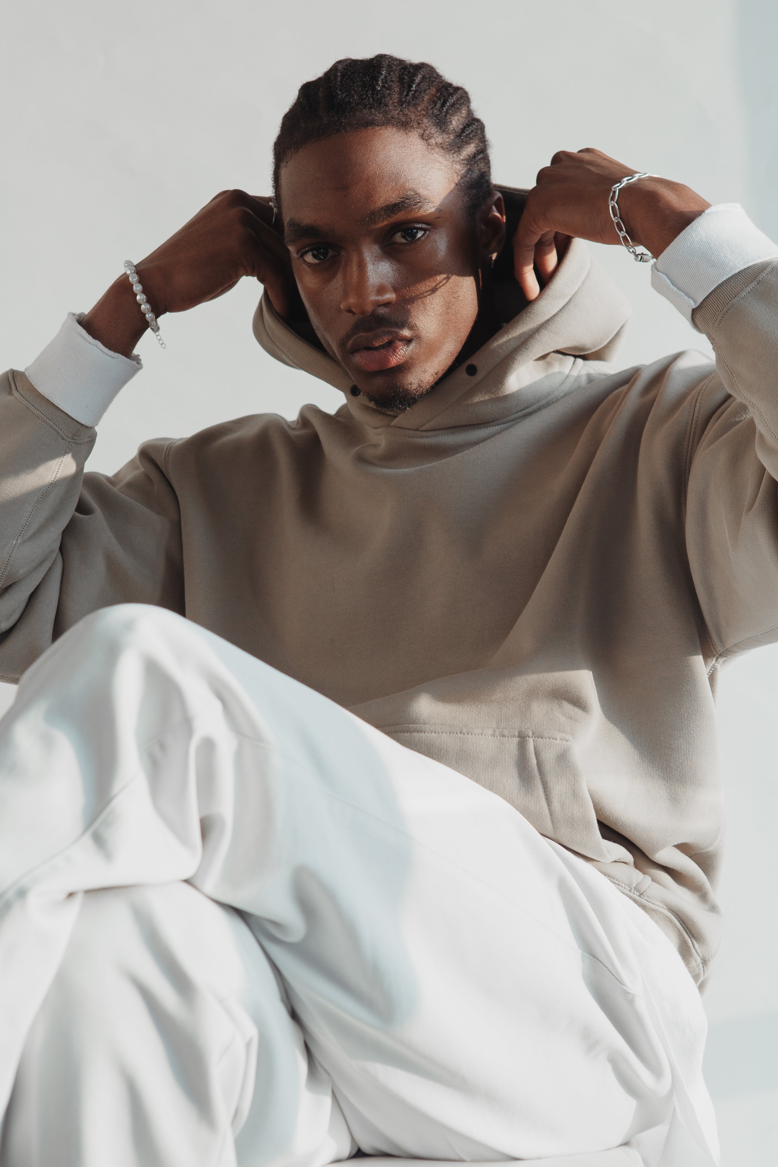 A male model sports light tan casual wear for Luxury Direct Online